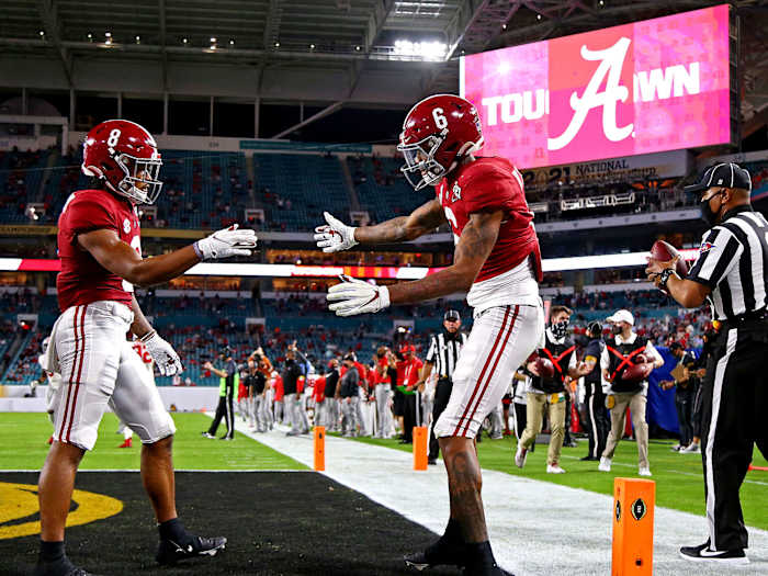 DeVonta Smith celebrates a touchdown with John Metchie III
